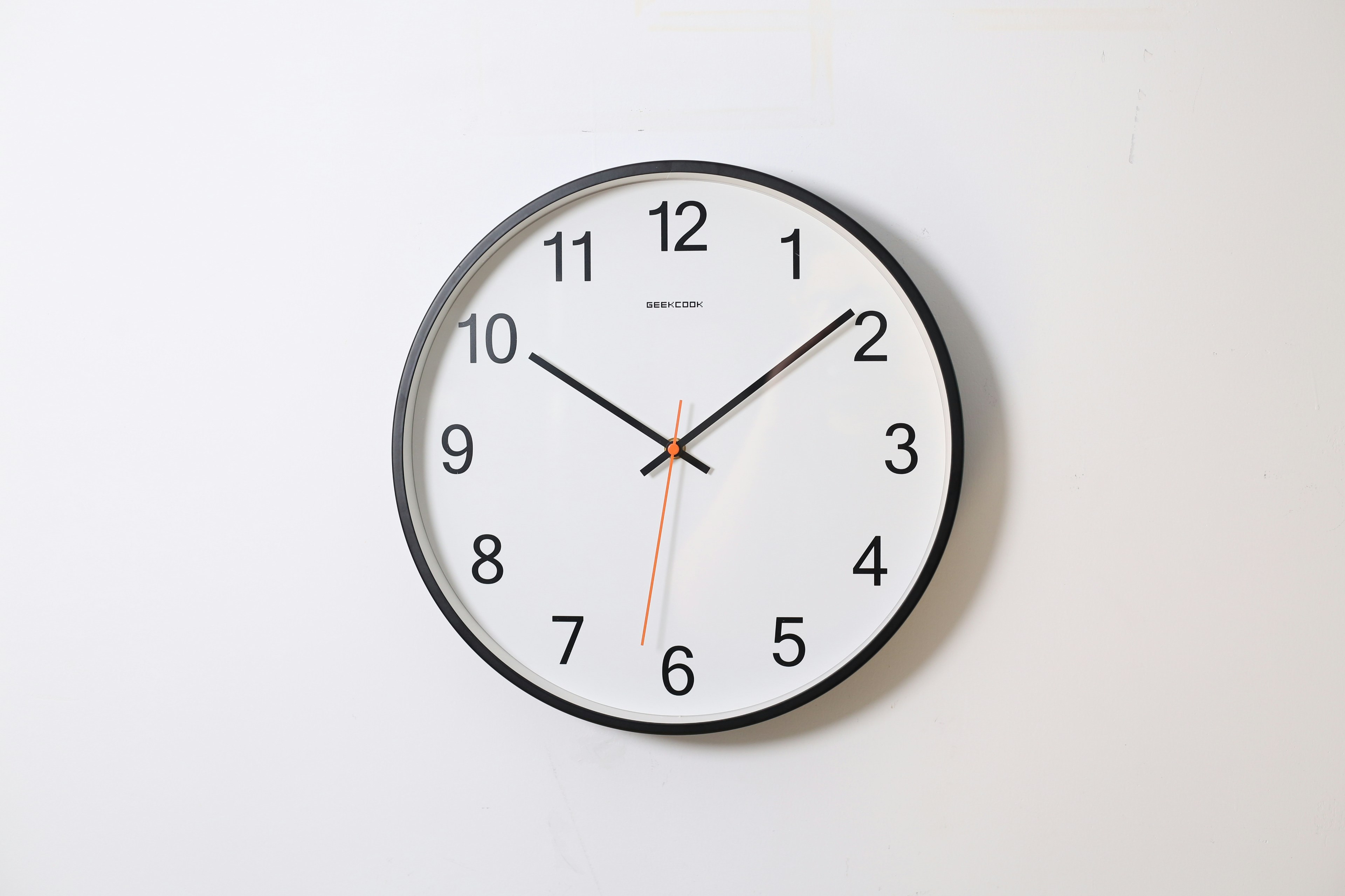 Round wall clock illustrating time and sequence