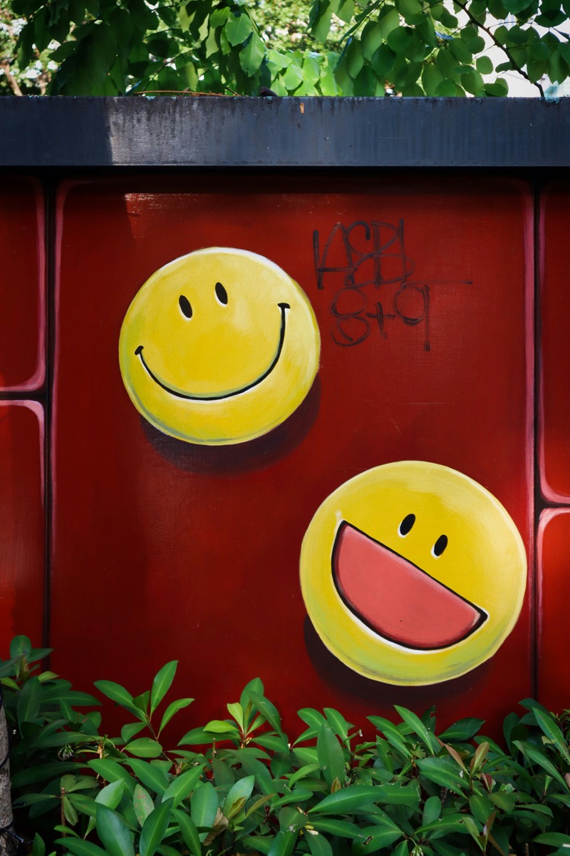 Smiley faces painted as street art on a wall