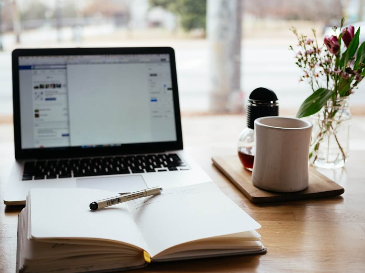 Student writing a research paper at a desk
