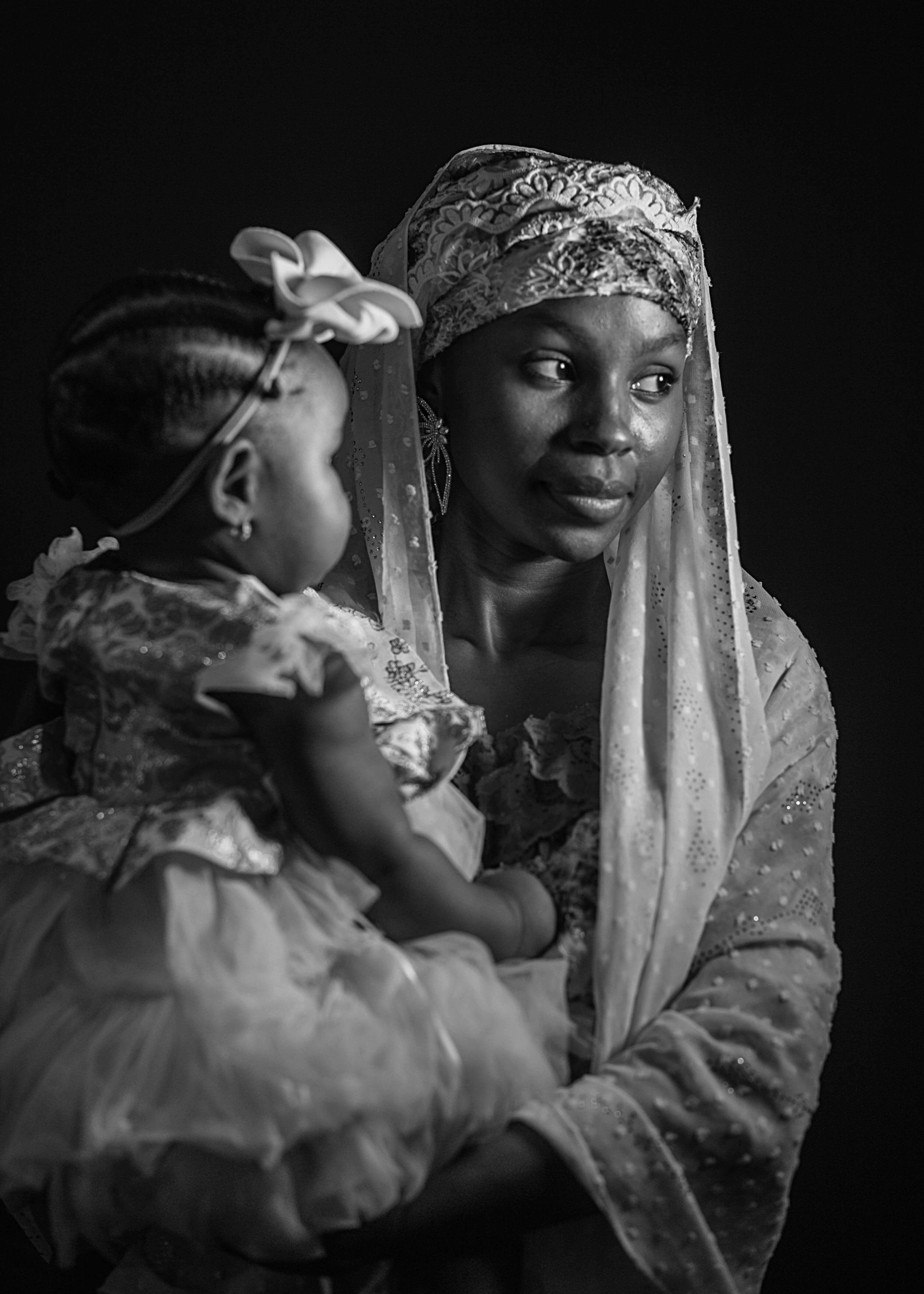 African mother in traditional dress holding her baby