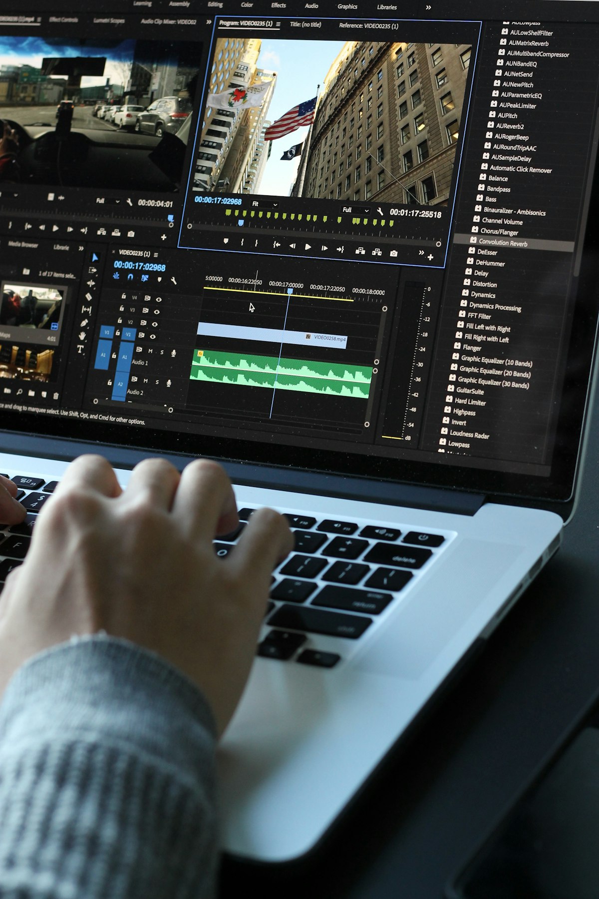 A content creator editing video captions on a laptop