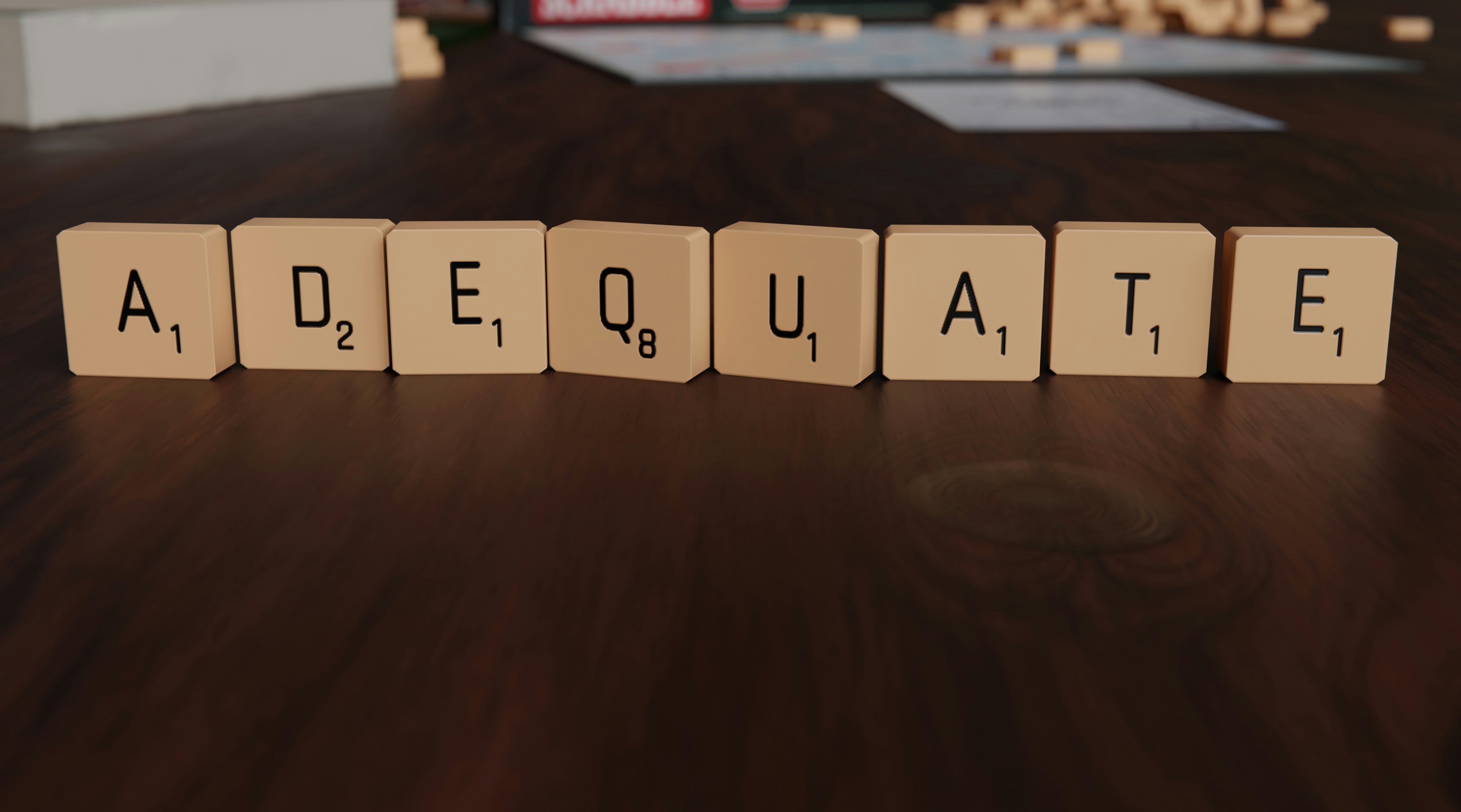 Scrabble tiles spelling words on a wooden board