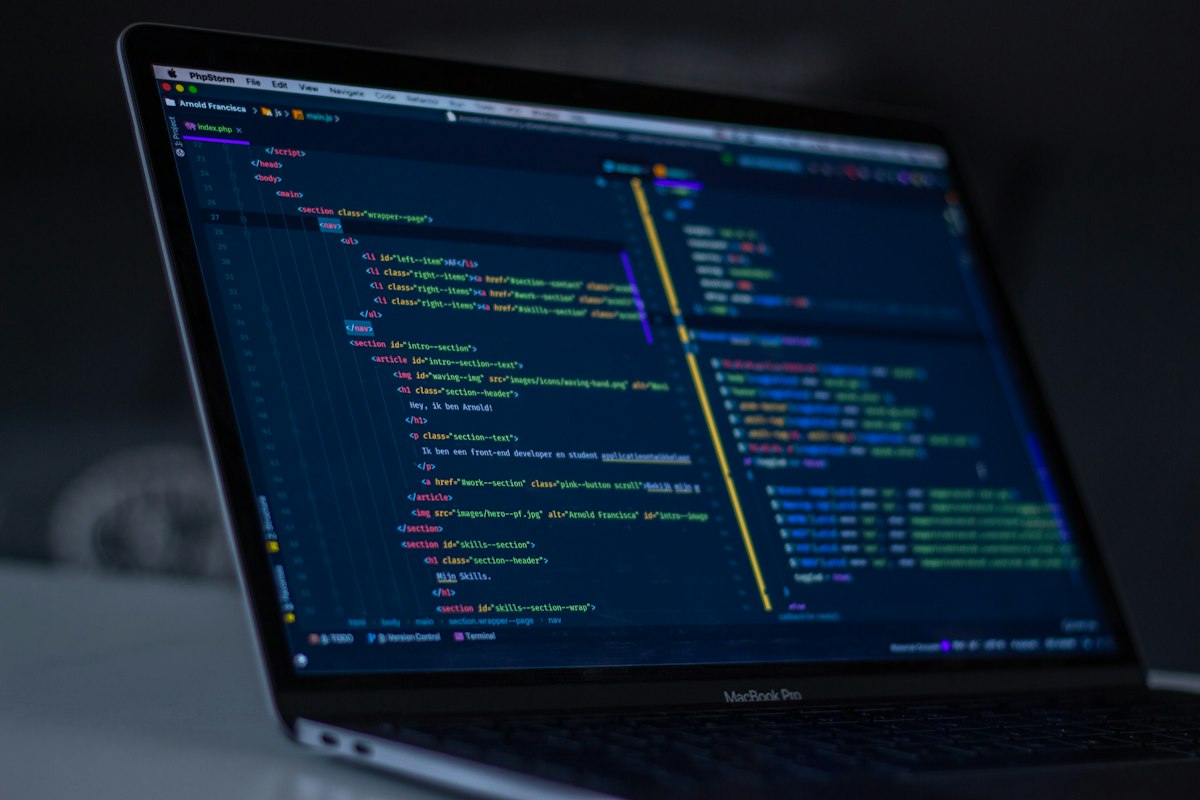 Laptop screen showing code and documentation edits