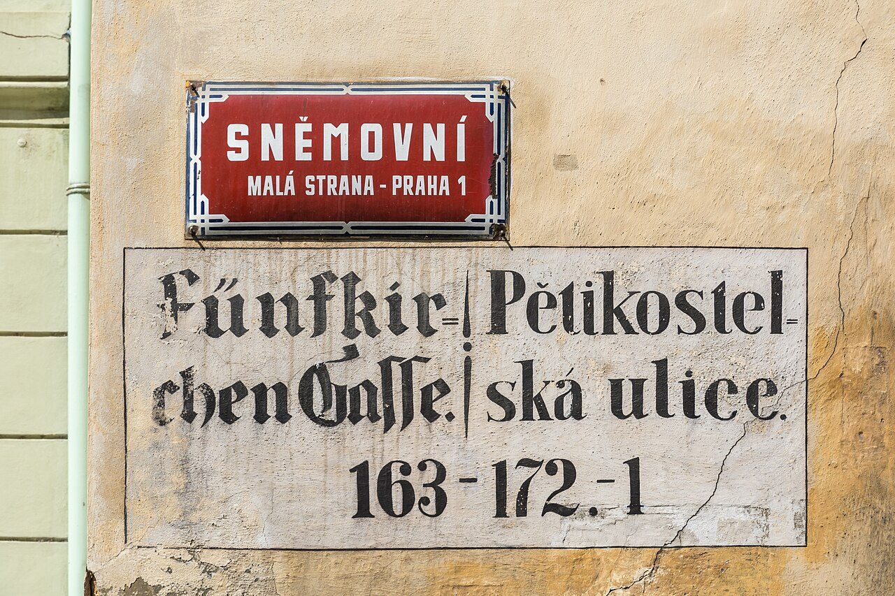 Historic bilingual German–Czech street sign in Malá Strana, Prague, with Czech diacritics — Photo by Uoaei1, CC BY-SA 4.0, via Wikimedia Commons