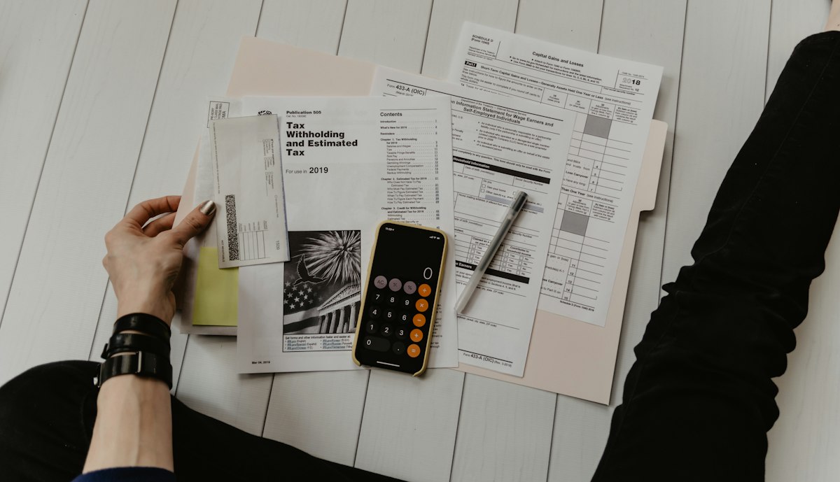 Calculator, charts, and paperwork on a desk — Photo on Unsplash